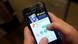 A man holds a phone showing the dating app Grindr A man holds a phone showing the dating app Grindr