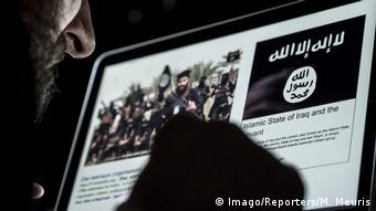 A man reads a website advertising for Islamic State
