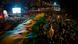 Protesters in the streets of Brazil hold up a big green and yellow flag Protesters in the streets of Brazil hold up a big green and yellow flag