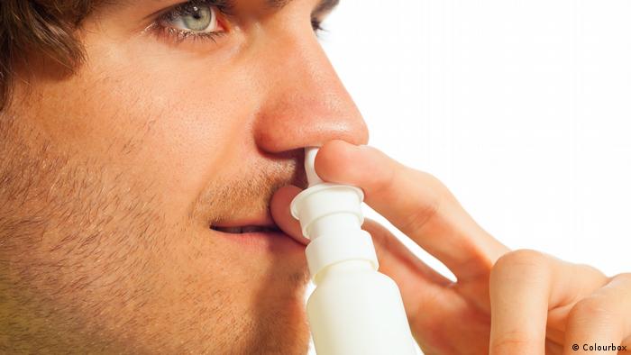 A man using nasal spray 