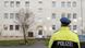 Police officer standing in front of house in Benndorf Police officer standing in front of house in Benndorf