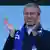 Roman Abramovich claps at a Chelsea FC match