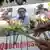 Women place flowers on pictures of three press workers after their deaths were confirmed.