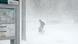 A traveler navigates snow and ice A traveler navigates snow and ice
