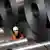 A worker from Thyssenkrupp among rolls of steel