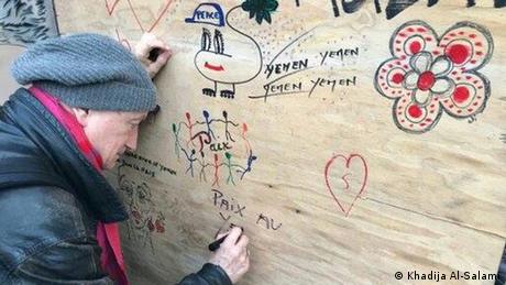 A man drawing on a board (Khadija Al-Salami)