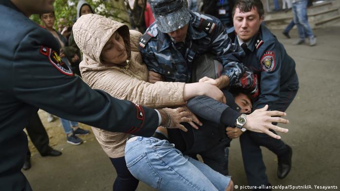 Police grabbing a protester violently 