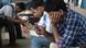 Men in India staring at their mobile phones Men in India staring at their mobile phones