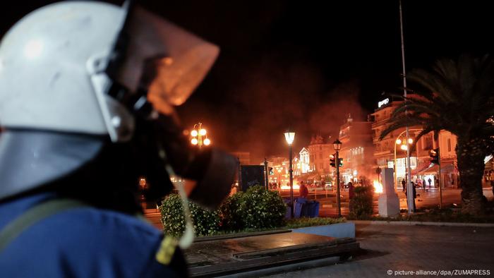 Riot police trying to keep protesters away from migrants during clashes in Mytilene