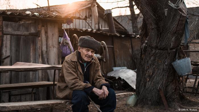 Ivan Ivanovych in front of his house in the village of Paryshiv