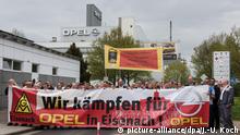 Opel workers protest cuts as PSA boss digs in