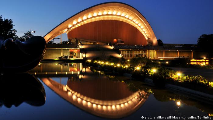 Evening image of Berlin's Haus der Kulturen reflecting in water.