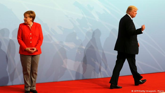 German Chancellor Angela Merkel and US President Donald Trump gesture at the beginning of the G20 meeting in Hamburg