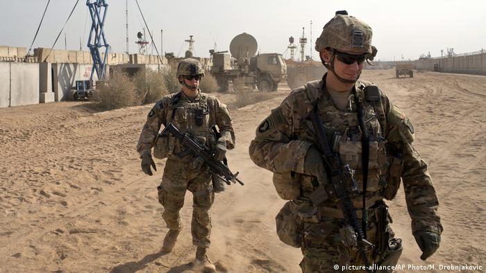 U.S. Army soldiers move through Qayara, Iraq