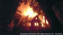 FILE - In this Jan. 4, 2013 file photo, a firefighter, left, works to extinguish the flames of the home of Werner Luchsinger and his wife, Vivian MacKay, who died defending their property, in Vilcun, on the outskirts of Temuco, Chile. A Chilean court on Wednesday, Oct. 25, 2017, acquitted 11 Mapuches in the arson killing of the elderly couple, saying there was insufficient evidence that they attacked the pair's home on land the indigenous group claims as ancestral territory. (Hector Andrade/Agenciauno, File) |