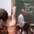A student raises her hand in class