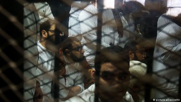 Defendants attend the trial session behind a cage in Cairo, Egypt on January 9, 2018.