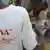A man in a white t-shirt with the slogan 'Ebola out of Congo!' at a meat market  