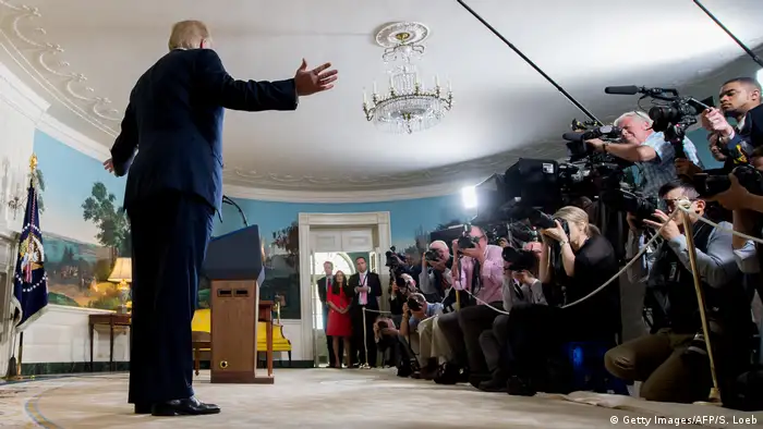 Trump makes an announcement to a room full of journalists