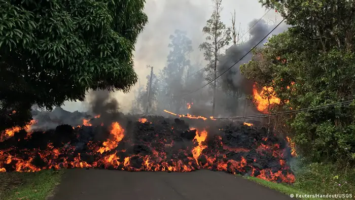 A lava flow from the Kilauea volcano, moves on a street in Leilani Estates in Hawaii (Reuters/Handout/USGS)