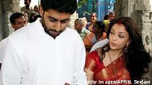 Tirupati, INDIA: Indian actors Abhishek Bachchan (L) and Aishwarya Rai hold hands during a visit to The Lord Venkatesh Wara Temple at Tirupati,some 550 kms south of Hyderabad,22 April 2007. Bollywood stars Aishwarya Rai and Abhishek Bachchan began life as Mr and Mrs Bachchan 21 April, after three days of wedding celebrations for Indian cinema's ultimate power couple. AFP PHOTO/NOAH SEELAM (Photo credit should read NOAH SEELAM/AFP/Getty Images)