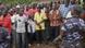 A crowd of Burundians and a soldier stand on the spot where an attack took place in early May A crowd of Burundians and a soldier stand on the spot where an attack took place in early May