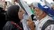 A man displaying an Israeli flag confronts a Palestinian woman holding a keffiyeh A man displaying an Israeli flag confronts a Palestinian woman holding a keffiyeh