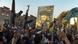 Men loyal to Muqtada al-Sadr wave guns in the air Men loyal to Muqtada al-Sadr wave guns in the air