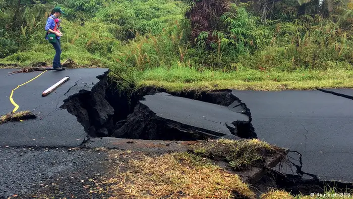 A geologist inspects cracks on a road following a volcano eruption in Hawaii (Reuters/USGS)