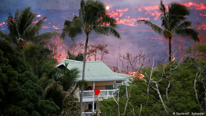 Flow of lava seen behind a house in Hawai (Reuters/T. Sylvester)