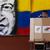 A Venezuelan man votes with a mural of Chavez in the background