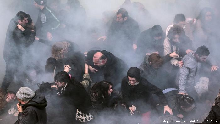 Protesters scattering after Turkish police use water cannons and tear gas to disperse crowds