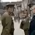 film still shows woman with Russian soldiers from Anonyma - Eine Frau in Berlin