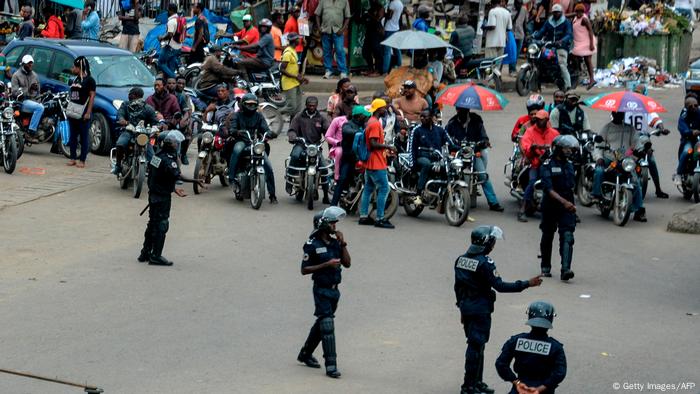 Cameroonian police men cordon off a street