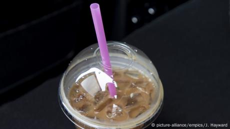 A straw pokes out of a plastic cup