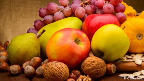 A mix of apples, pears, grapes and nuts.