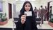 A Saudi Arabian woman holds up her new driver's license A Saudi Arabian woman holds up her new driver's license