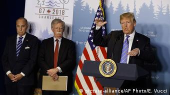 Donal Trump with John Bolton, speaking at a podium.