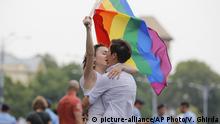 Two girls kiss holding a rainbow flag during the gay pride parade in Bucharest, Romania, Saturday, June 9, 2018. People taking part in the gay pride parade in the Romanian capital demanded more rights and acceptance for same-sex couples. (AP Photo/Vadim Ghirda) |
