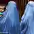 Zwei Burka-tragende Frauen mit einem Kind
