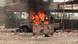 A military truck with an anti-aircraft gun is in flames. A military truck with an anti-aircraft gun is in flames.
