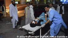 16.06.2018, Afghanistan, Nangarhar: Ein verwundeter Mann wird von einem Sanitäter auf einer Trage transportiert. Bei einem Selbstmordanschlag der Terrormiliz Islamischer Staat (IS) auf ein Friedenstreffen von Taliban, Sicherheitskräften und Zivilisten in Ostafghanistan sind nach offiziellen Angaben 20 Menschen getötet worden. 16 weitere seien verletzt worden, sagte der Sprecher der Provinz Nangarhar, Attaullah Chogiani, am Samstag. Foto: Mohammad Anwar Danishyar/AP/dpa +++ dpa-Bildfunk +++ |