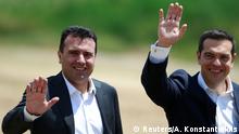 Macedonian Prime Minister Zoran Zaev and Greek Prime Minister Alexis Tsipras react after the signing of an accord to settle a long dispute over the name of Republic of Macedonia in the village of Otesevo, Macedonia June 17, 2018. REUTERS/Ognen Teofilovski