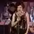 Macki Messer film still shows woman singing on stage