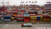 FILE PHOTO: A container truck moves past containers at the Yangshan Deep Water Port in Shanghai, China April 24, 2018. REUTERS/Aly Song/File Photo