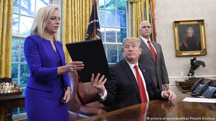 US President Donald Trump signs an executive order to end the separation of children from their parents