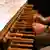 Clunched fists held above wooden keys of a carillon keyboard