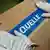 A Quelle sticker goes on a freshly packed box