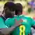 Senegal's Cheikhou Kouyate and Kara Mbodji embrace after losing to Columbia