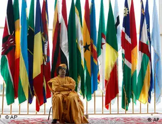 Back dropped with flags of AU members, Libyan leader Moammar Gadhafi rests while receiving attending delegations ahead of the opening session of the 13th African Union summit of heads of state and government in Sirte, Libya Wednesday, July 1, 2009. (AP Photo/Nasser Nasser)